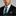 Man wearing a black suit with a Black and Light Blue Paisley and Stripe Tie and Accenting Square on a gray background