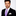 Man wearing a black suit with a purple tie on a white background