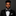 Man wearing a black tuxedo with a black geometric bow tie and white square on a dark background