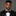 Man wearing a black tuxedo with a black geometric bow tie against a gray background