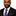 Man wearing a black suit with a Blue, Red and Yellow Paisley Tie and Blue, Red Stripe Pocket Square on a white background