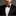 Man wearing a black suit with a Red Lines Bow Tie and Pocket Square on a gray background