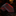Black and red patterned tie on a dark surface with a blurred background
