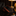 Black and copper folded tie on a dark surface with a blurred background