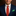 Man wearing a red tie with green patterns and a pocket square.