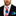 Man wearing a colorful tie and matching pocket square with a white shirt and black suit.