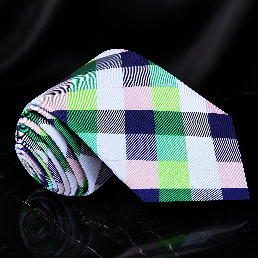 Plaid tie with green, blue, and pink pattern on a black background