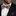 Man wearing a colorful checkered bow tie and blue reindeer pocket square.