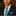Man in Christmas setting wearing blue with red stockings tie and square