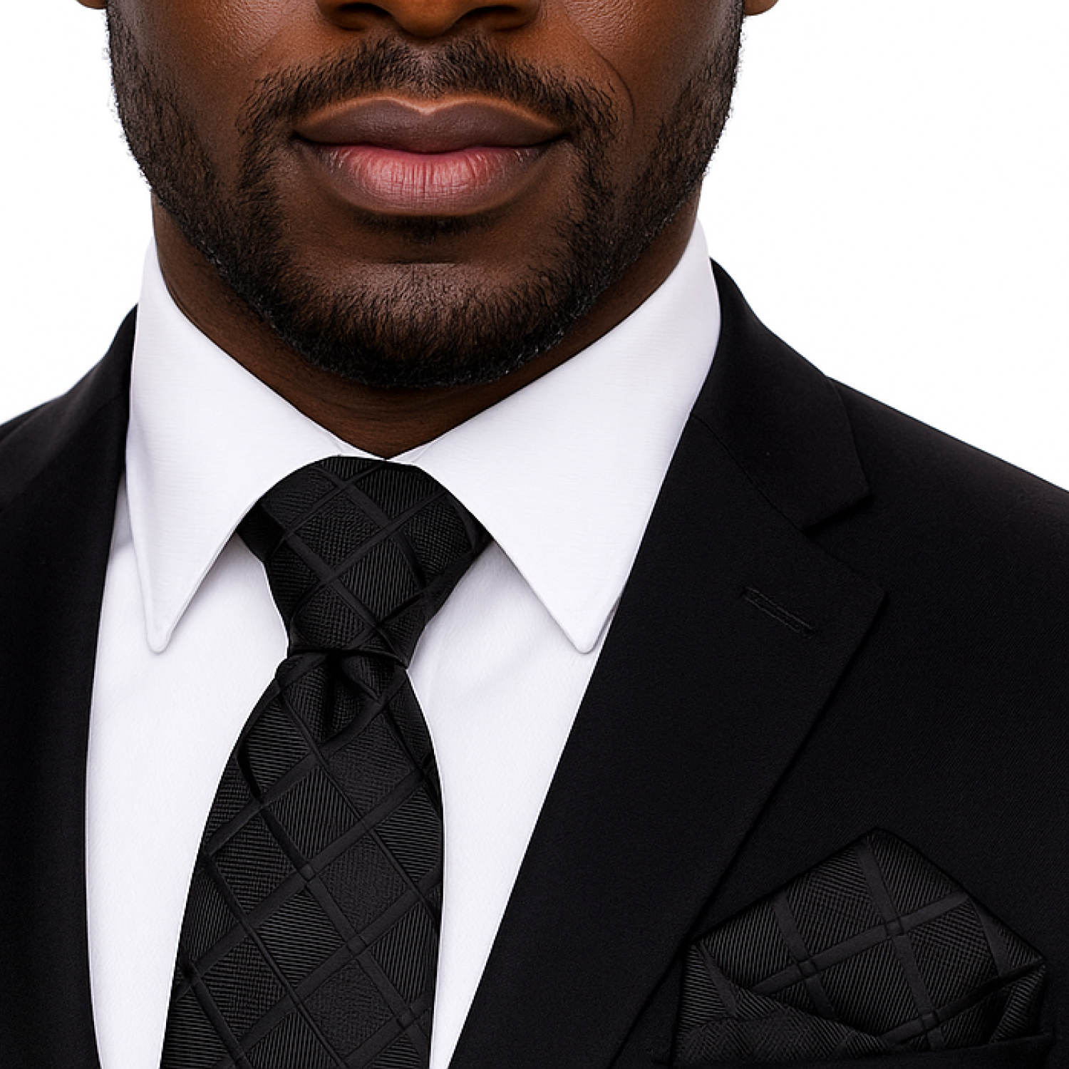 Man wearing a black suit with a white shirt and black tie on a white background