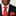 Man wearing a black suit with a red and yellow striped tie and pocket square.