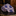 Folded blue paisley fabric on a dark surface with a blurred background