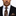 Man wearing a black suit with a white shirt, brown floral tie, and matching pocket square.