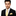 Man wearing a black suit with a yellow tie and pocket square on a white background