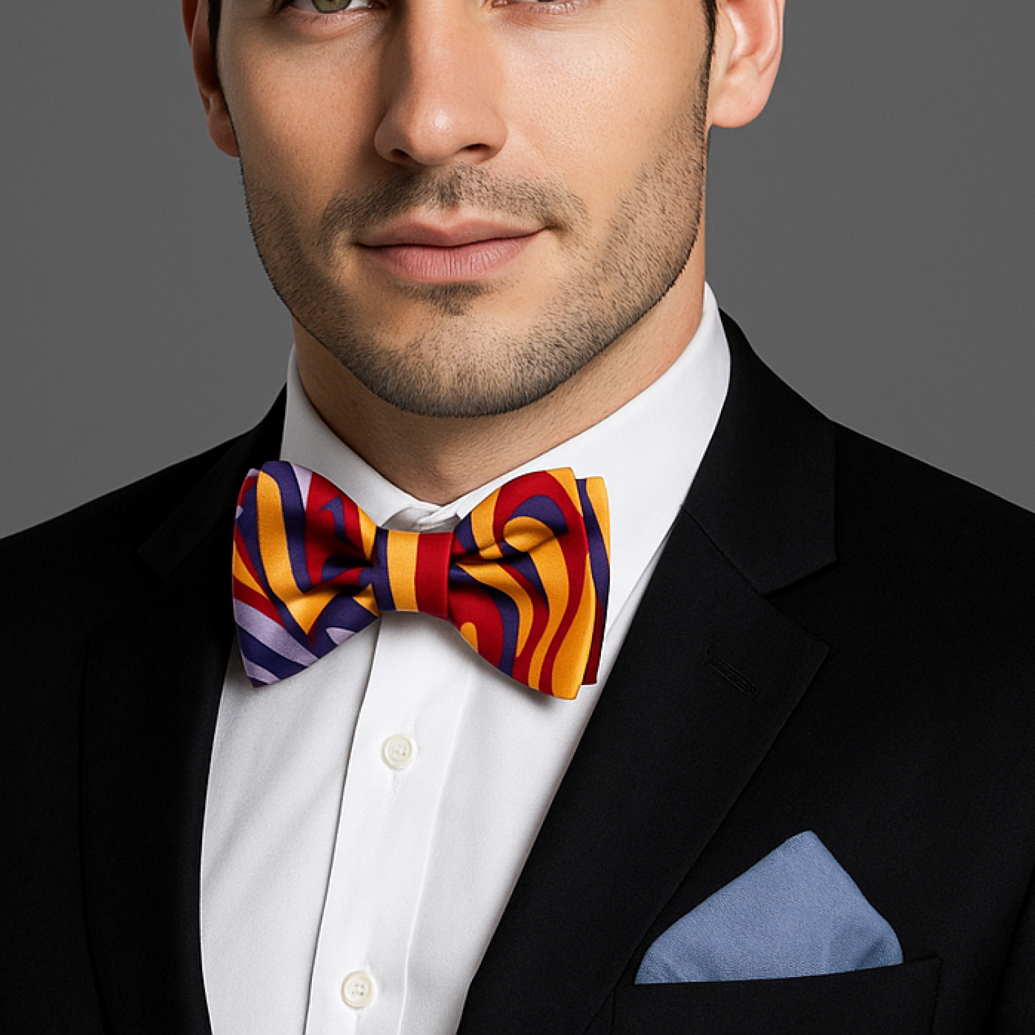 Man wearing a colorful bow tie with a black suit and white shirt.