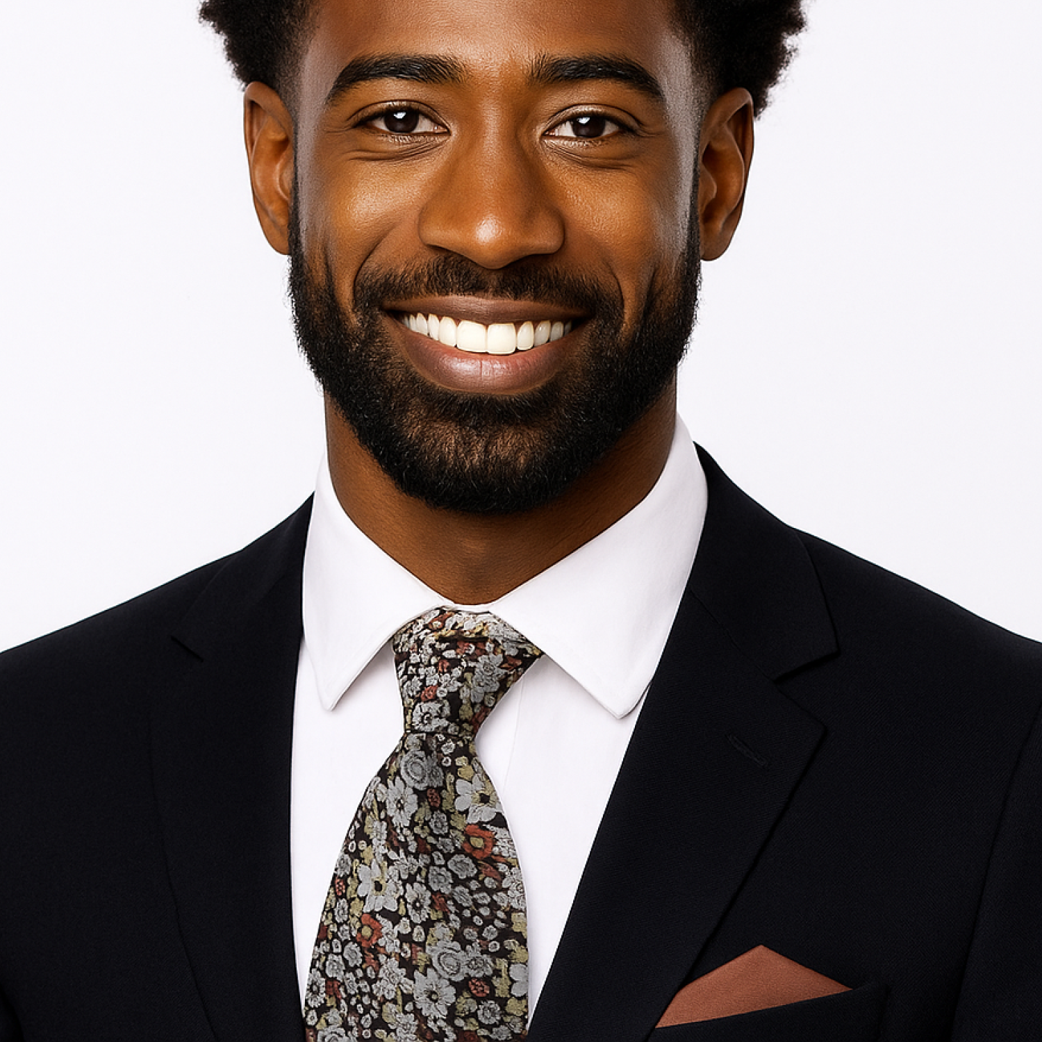 Man wearing a black suit with a patterned tie on a white background
