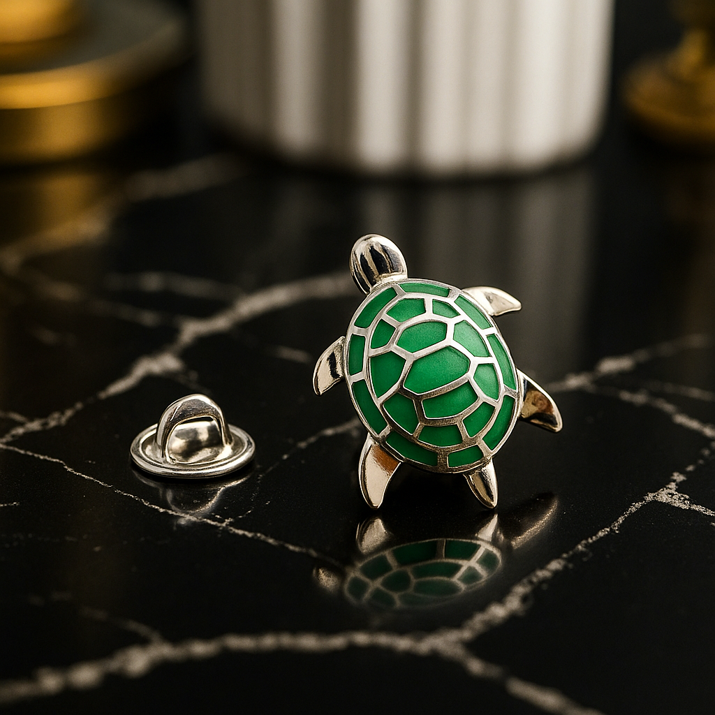 Green and silver turtle-shaped pin on a dark textured surface