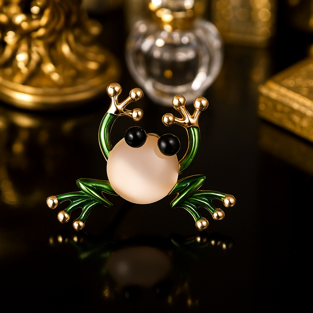 Decorative Green Frog Lapel Pin with gold accents on a reflective surface