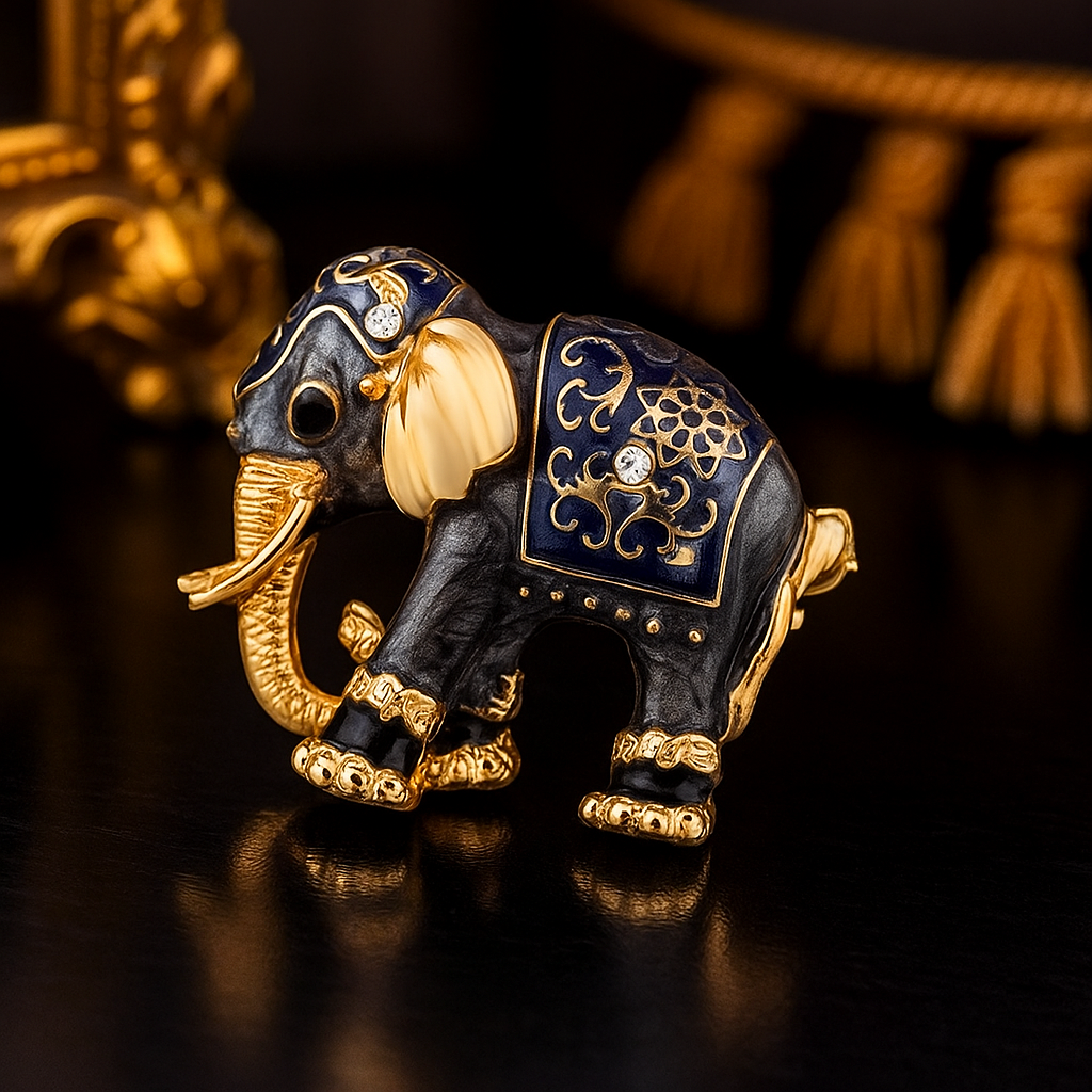 Decorative elephant figurine with gold and blue details on a dark background