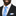 Man wearing a black suit with a blue patterned tie and pocket square on a white background
