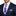 Man wearing a navy suit with a white shirt, purple polka dot tie, and matching pocket square.