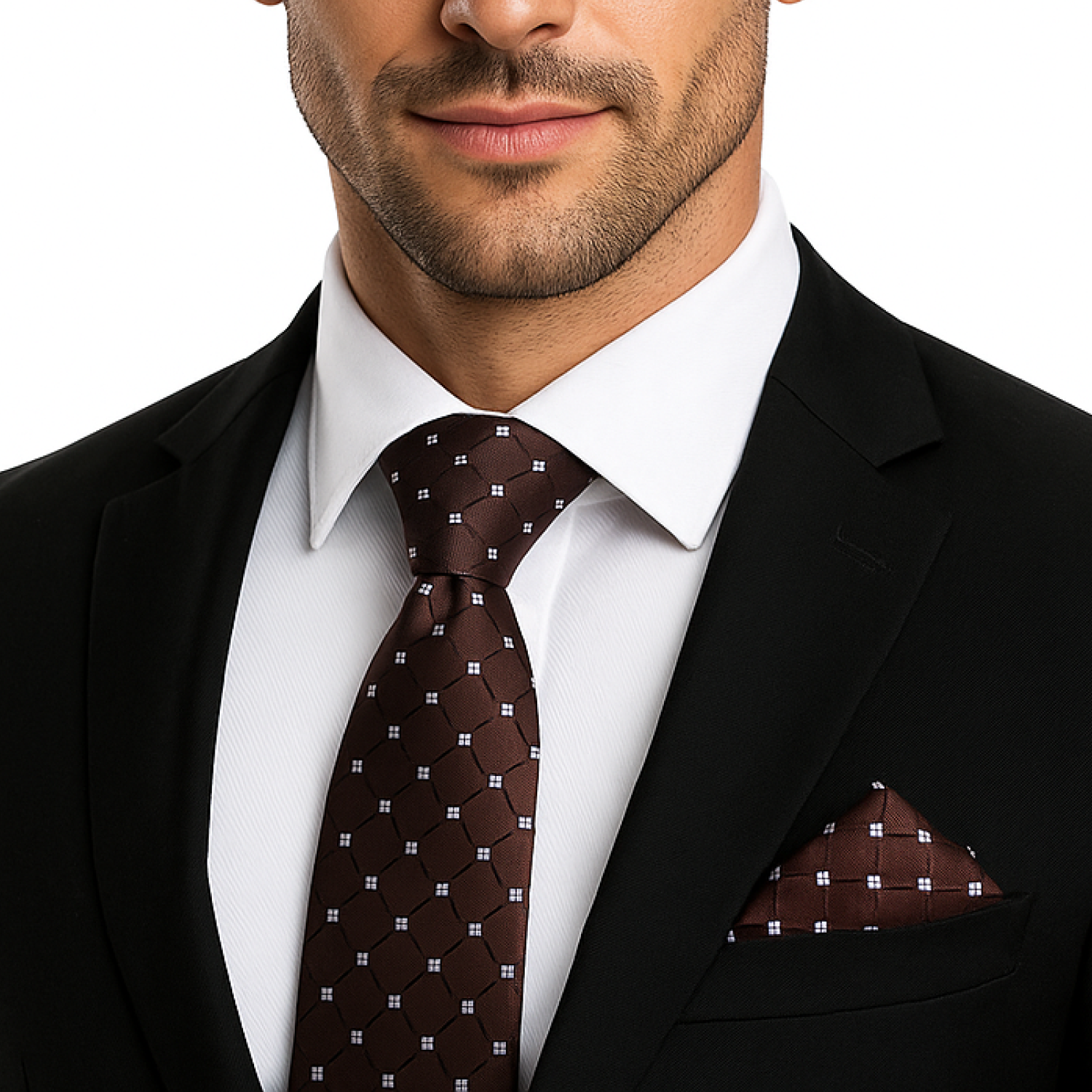 Man wearing a black suit with a white shirt and patterned brown tie and pocket square.