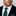 Man wearing green tie and accenting paisley square