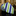 Green and blue striped tie on a dark surface with a blurred indoor background