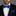 Man wearing a black suit with a blue geometric bow tie and pocket square against a gray background