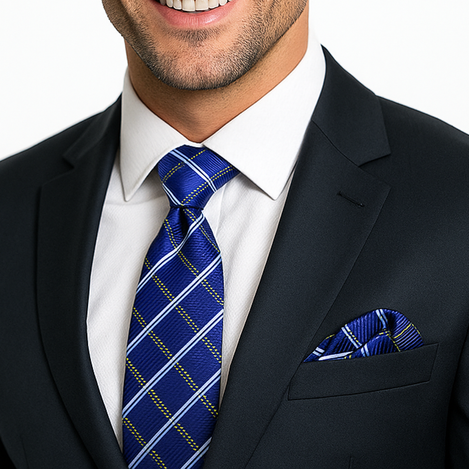 Man wearing a dark suit with a white shirt, blue plaid tie, and matching pocket square.