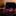 Pink and blue striped bow tie on a reflective surface with a blurred background