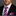 Man wearing a black suit with a pink and blue striped tie and pocket square on a gray background