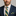 Man wearing green and yellow stripe tie and square