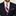 Man wearing a dark suit with a purple and yellow striped tie and matching pocket square.