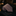 Rolled-up striped microstripe rust brown tie on a dark marble surface with a blurred background