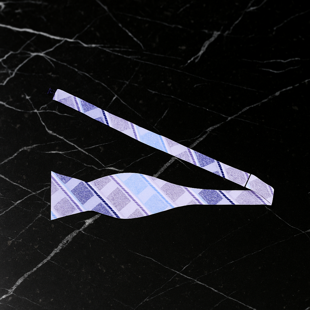 Blue Plaid Striped bow ties on a black marble surface