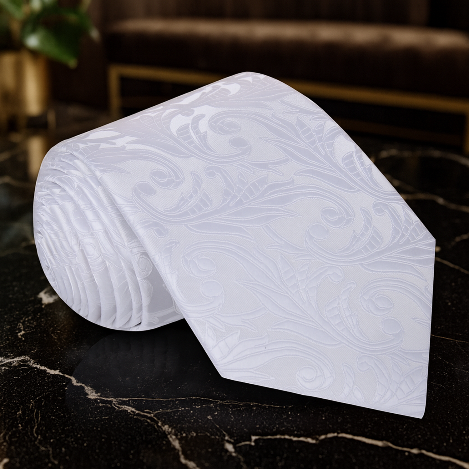 White tie with subtle pattern on a dark marble surface