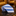 Blue and white striped tie on a reflective surface with decorative background