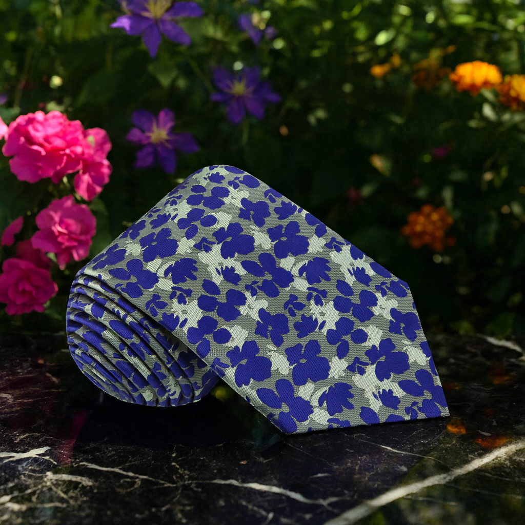 Tie with floral-patterned paper on a dark surface with flowers in the background