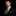 Man wearing a dark suit with an orange and black patterned tie and pocket square on a black background