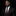 Man wearing a black suit with a patterned tie and pocket square on a black background