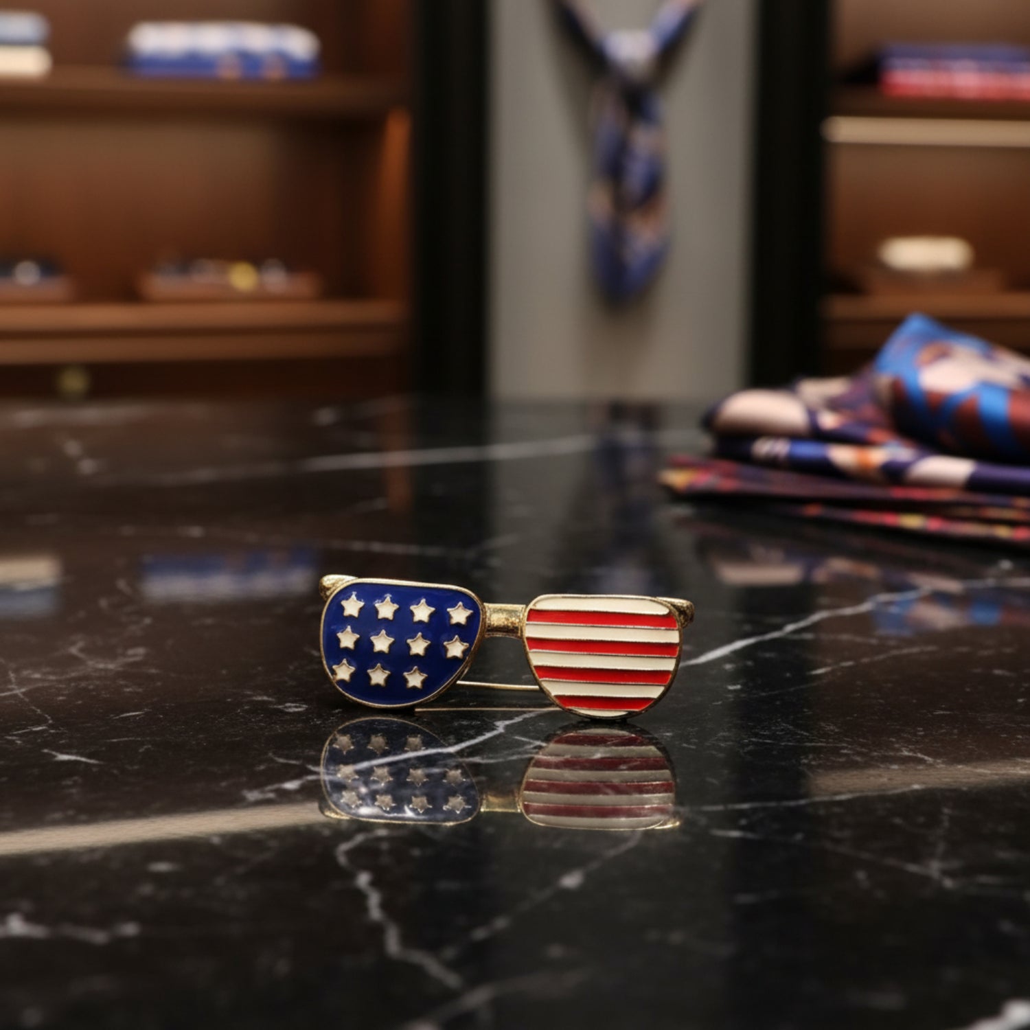 American flag lapel pin on a reflective surface with a blurred background