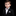 Young boy in a formal suit with a bow tie and pocket square on a black background