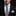 Man wearing a black suit with a Abstract Graphic Necktie Black & White with Teal and Pink Accents with Accenting Square 