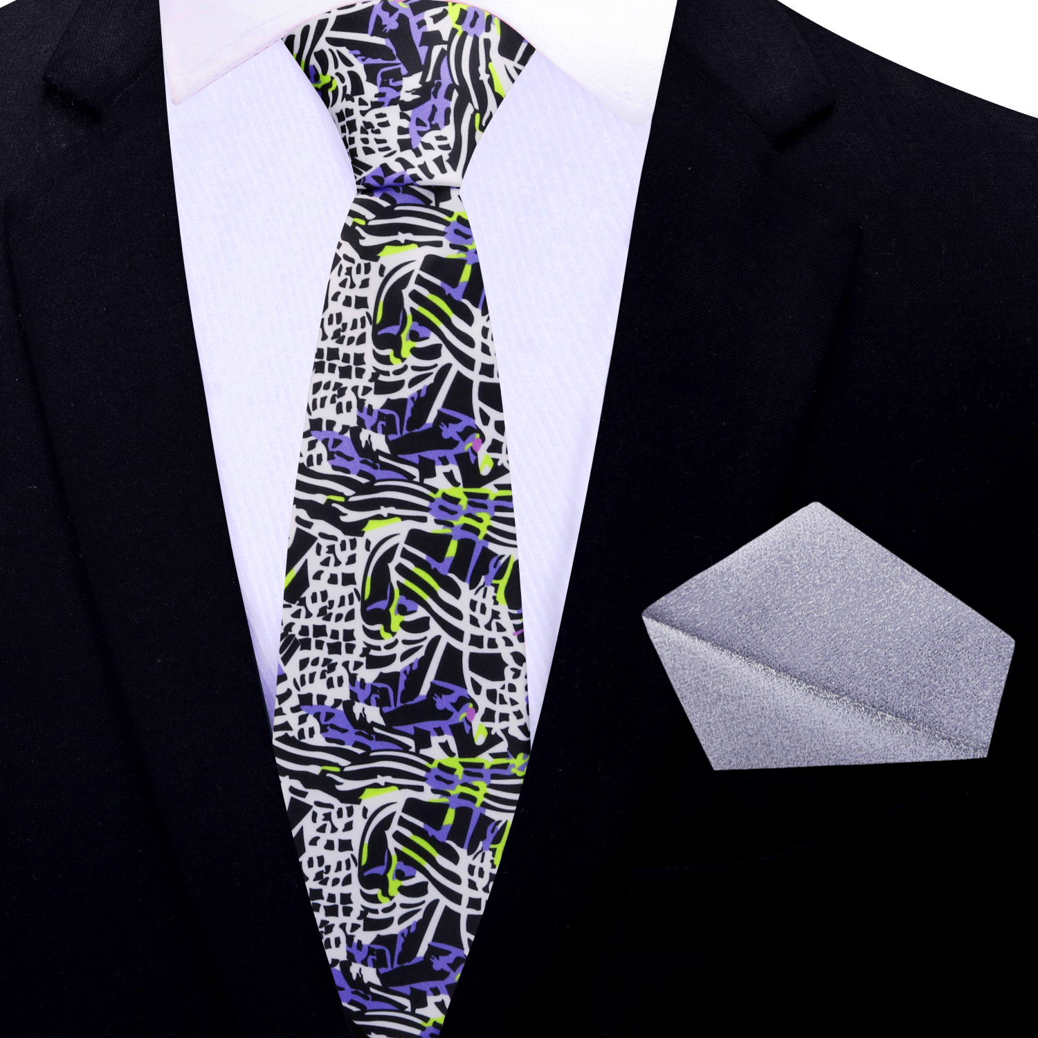 Patterned thin tie and matching pocket square on a black suit jacket.