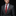 Man wearing a gray suit with a red tie and pocket square on a black background