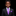 Young boy in a black suit with a purple tie and pocket square on a black background