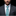 Man wearing a gray suit with a blue patterned tie and pocket square on a black background