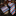 Plaid tie and pocket square set on a dark marble surface with a clothing store background.