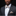 Man wearing a dark suit with a light-colored bow tie and pocket square against a black background